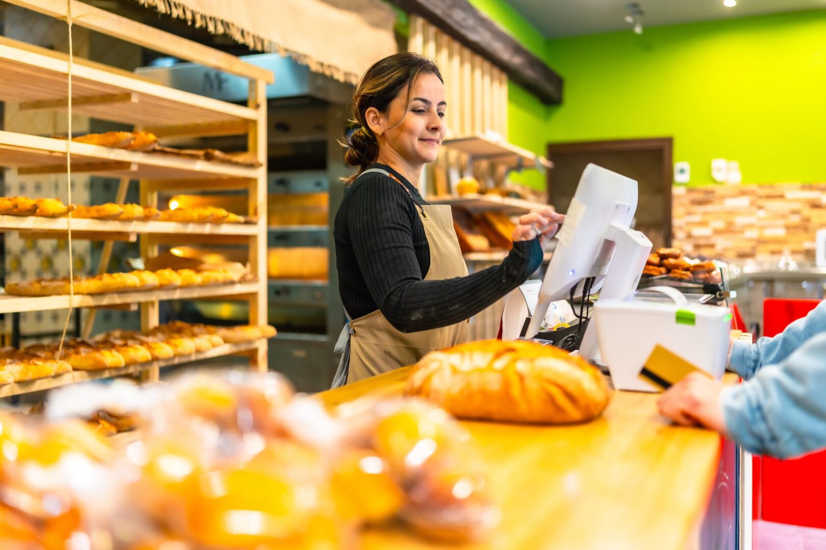 Bakery cashier assisting a customer