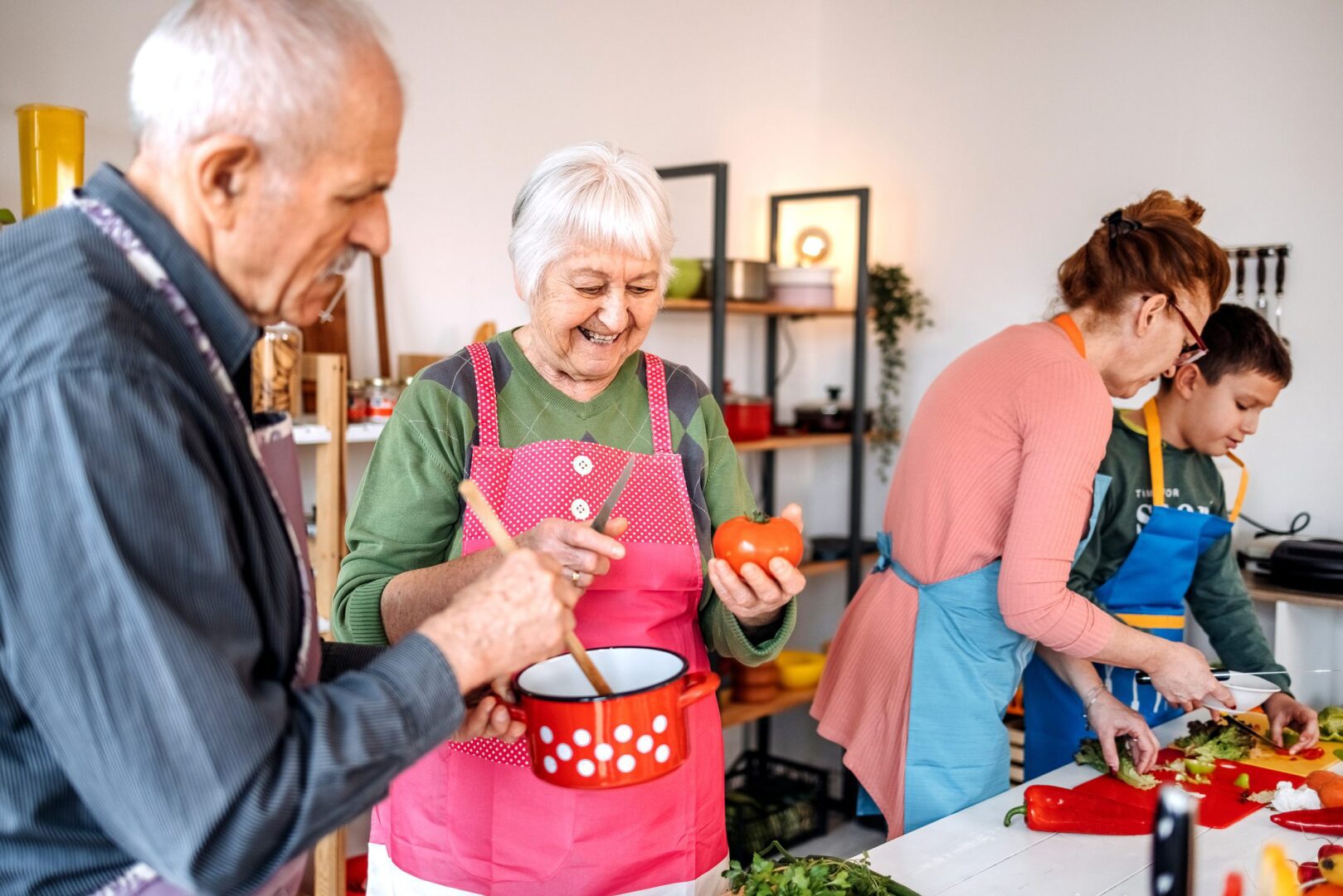 Family members having fun in the kitchen with preparing healthy meal using fruits and vegetables